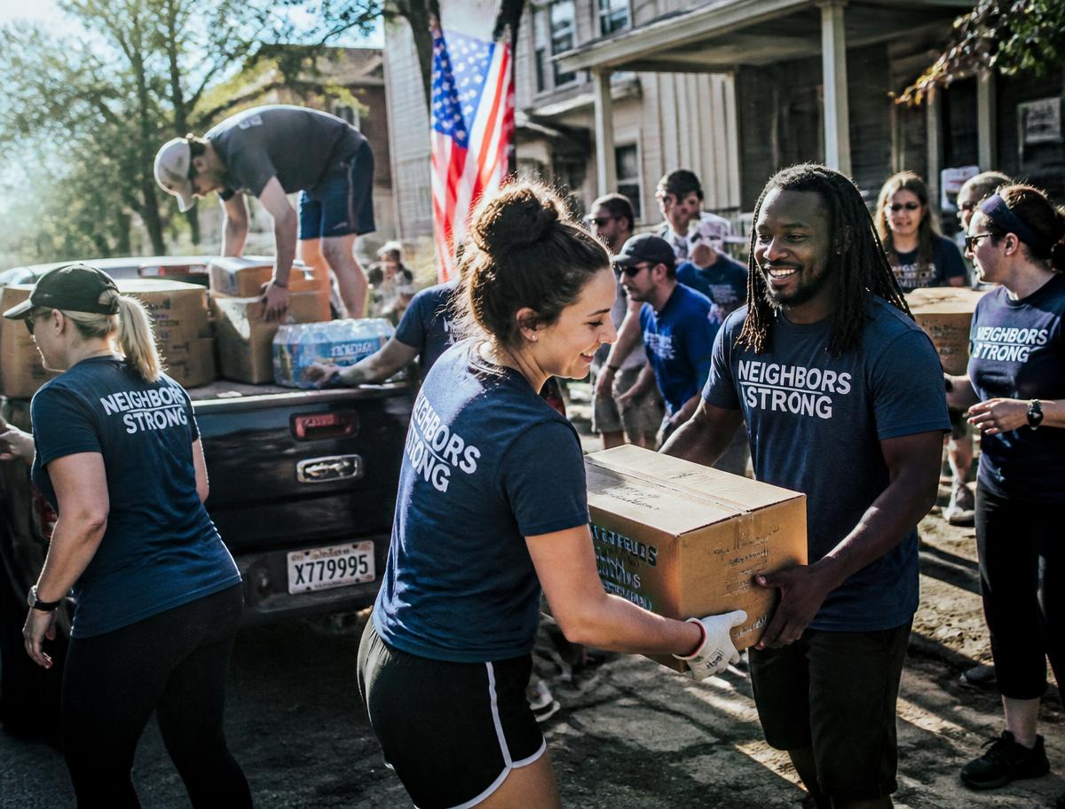Volunteers unloading relief supplies from a pickup truck